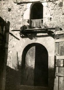 Façana d'una casa del carrer Lladó de Vilanant, amb portal adovellat de punt rodó, amb data de 1551. 1925
